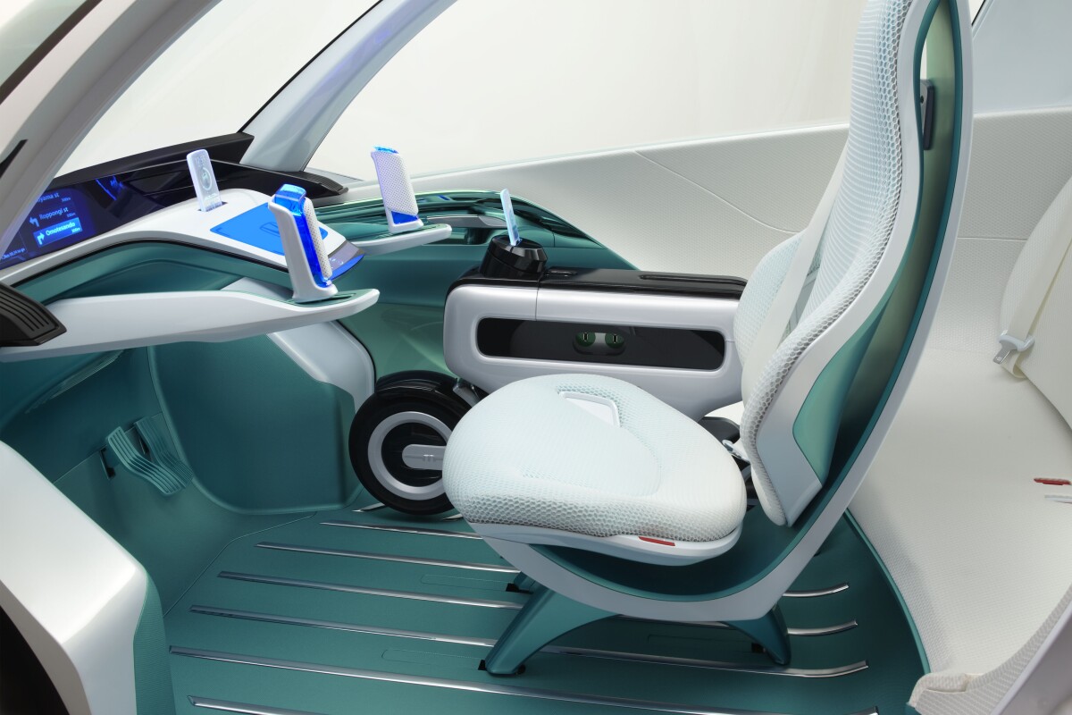 An interior view of the Micro Commuter Concept shows the Motor Compo stowed next to the driver.