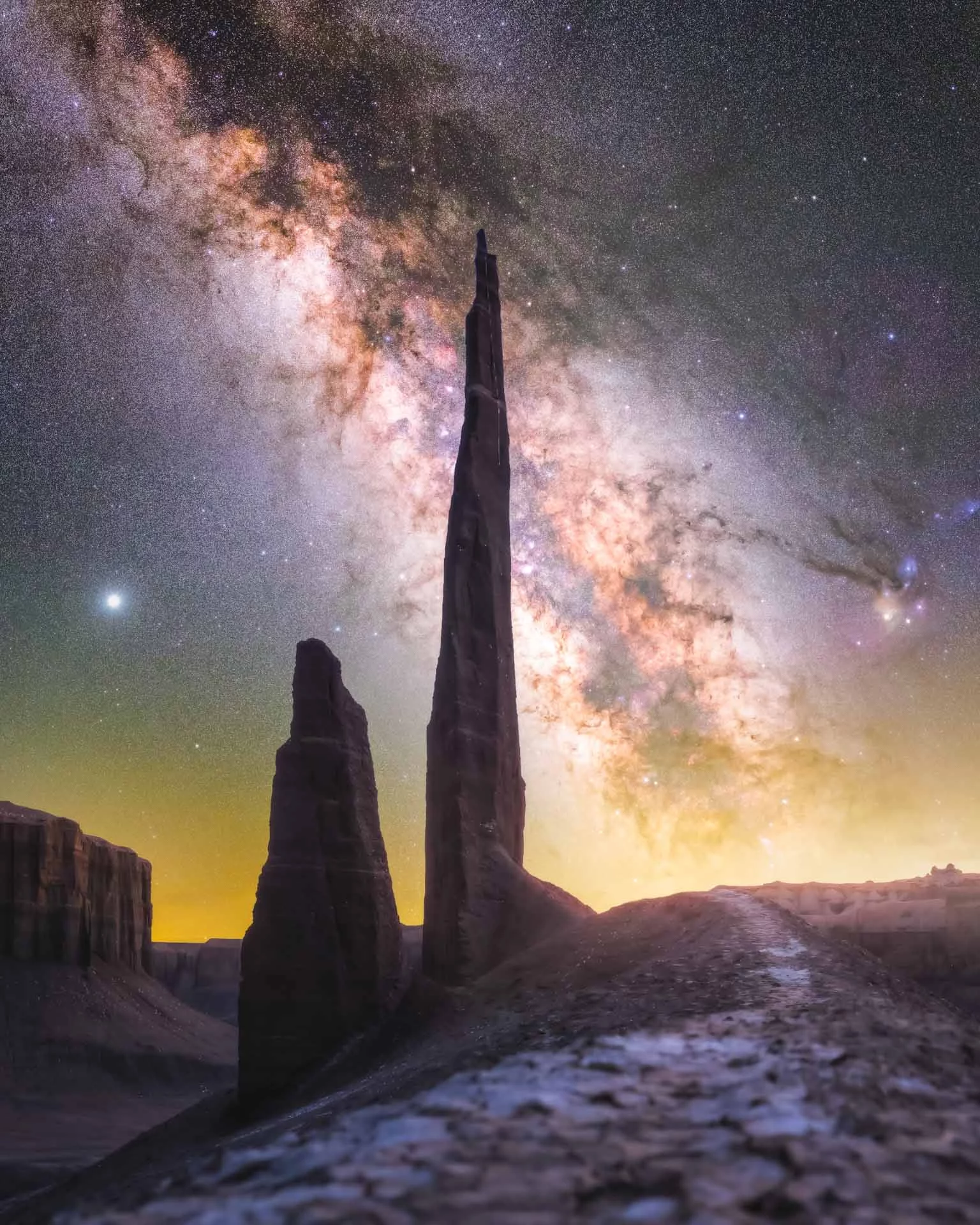 Starlit Needle. The Milky Way's stars shine bright enough to cast visible shadows on the ground, in the badlands of Utah, USA