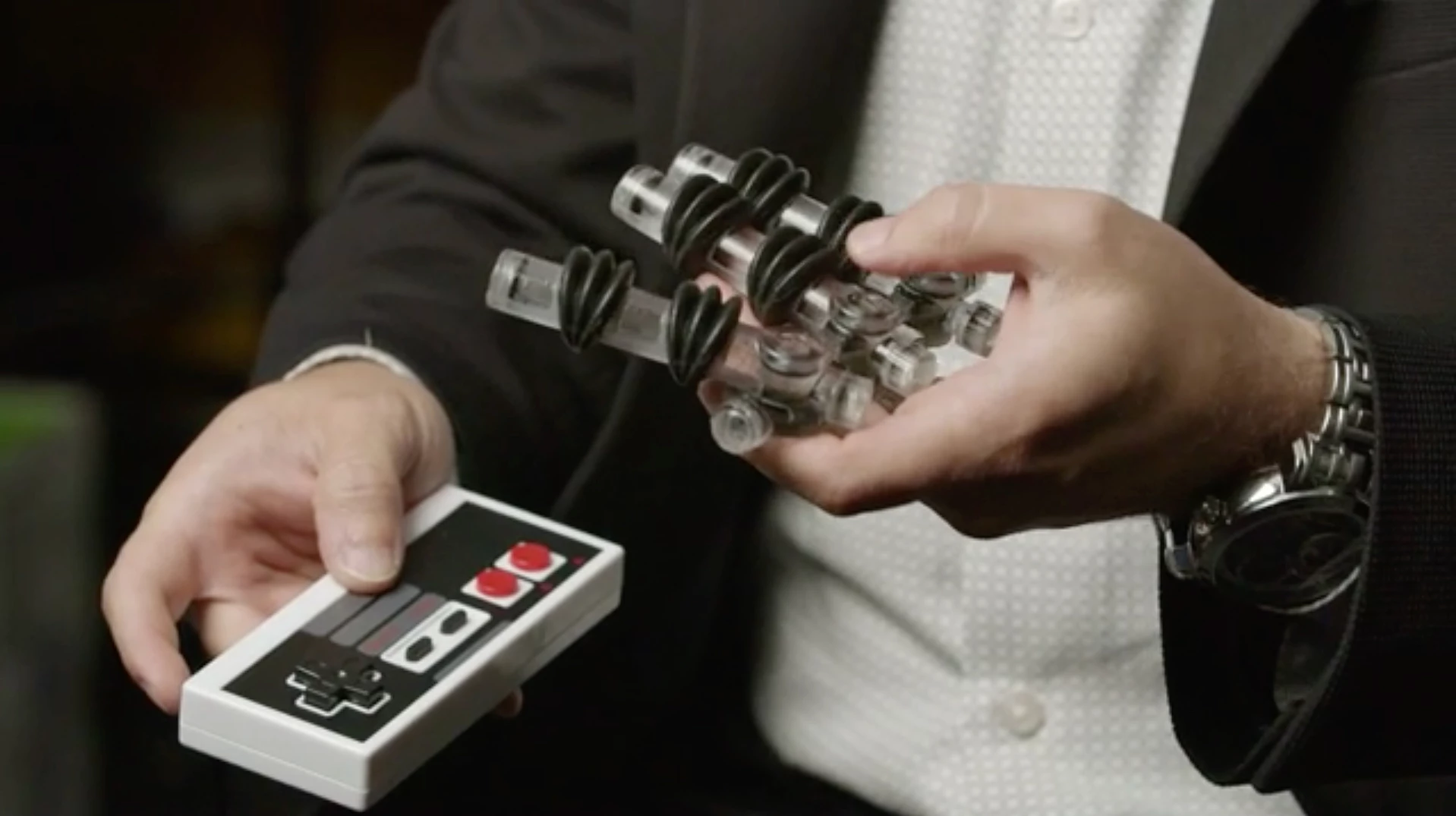 The soft robotic hand, with the fluidic transistors visible at the base of each finger
