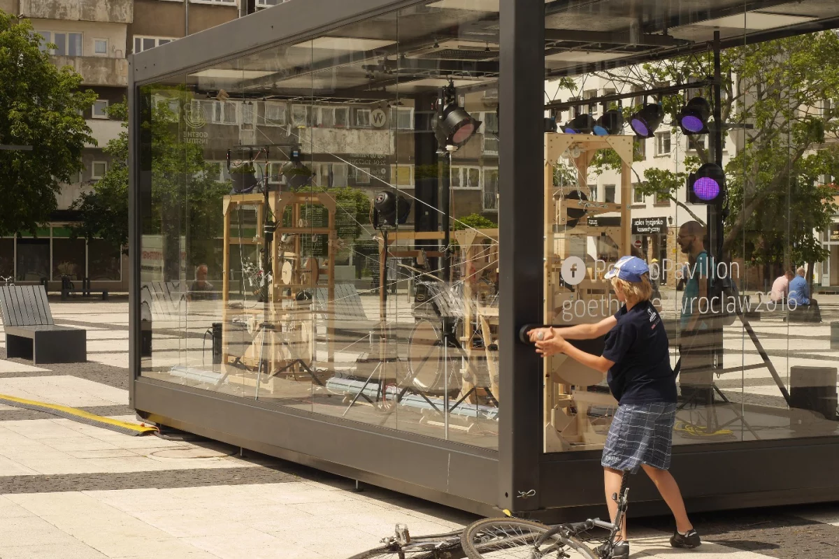 The musical cacophony is activated by a huge hand crank to the right of the transparent glass case