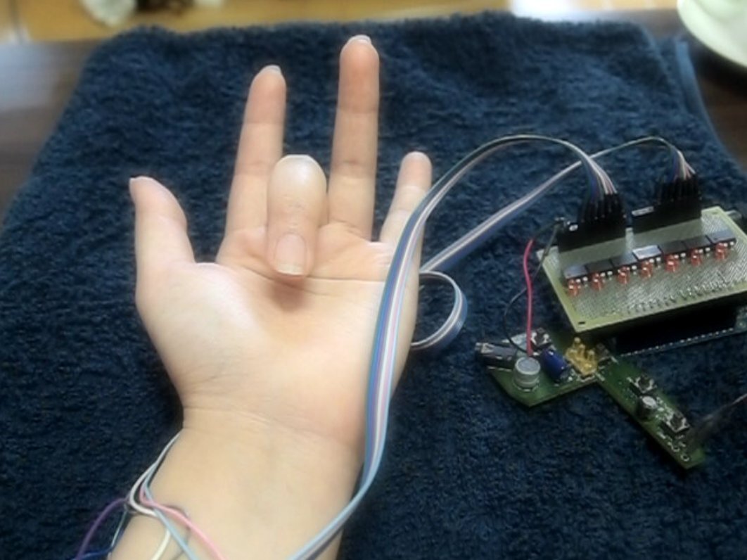 PossessedHand stimulates muscles in the forearm to move a wearer's finger (Photo: Emi Tamaki and Jun Rekimoto / University of Tokyo)