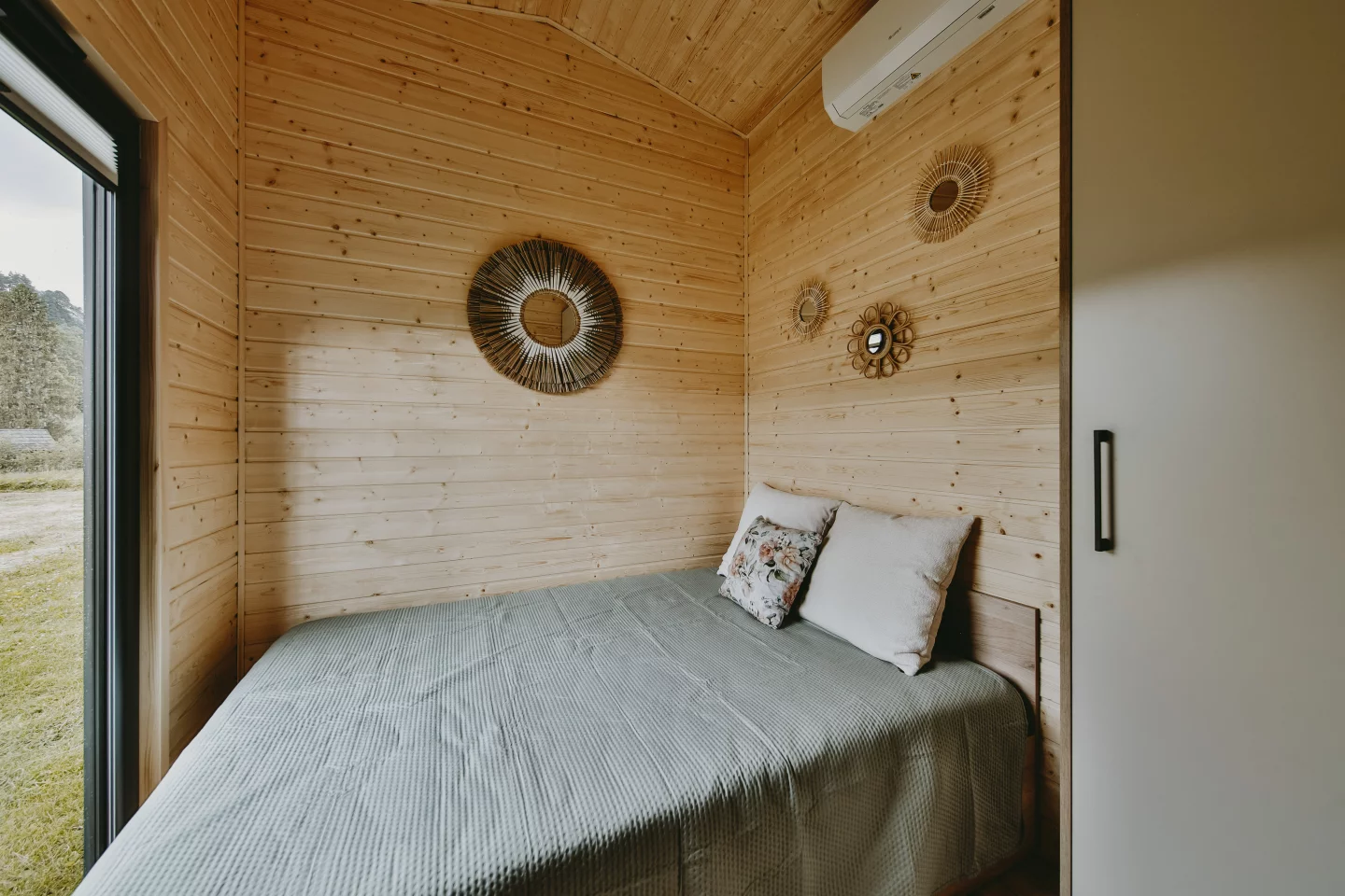 The Alan's downstairs master bedroom includes a double bed, storage space, and a large window