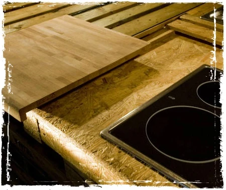 The work station includes an electric stove top, oven and chopping board