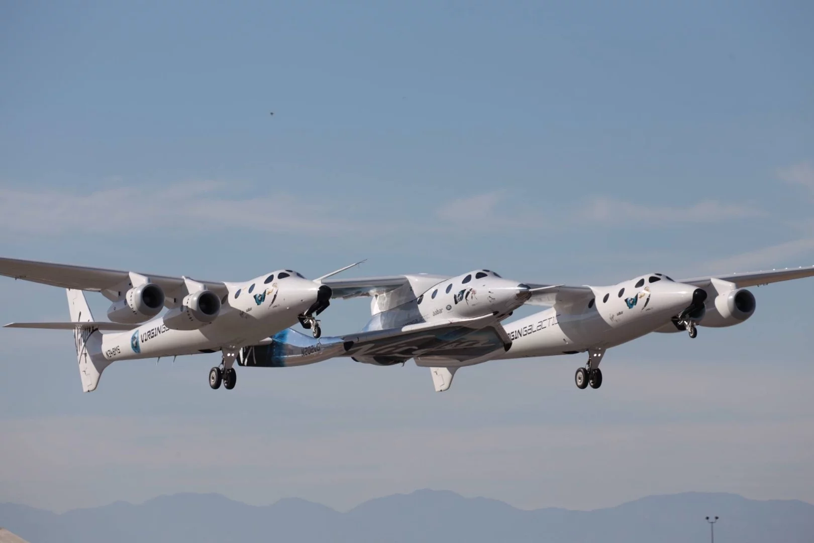 Virgin Galactic's spaceplane is carried into the air by its mothership