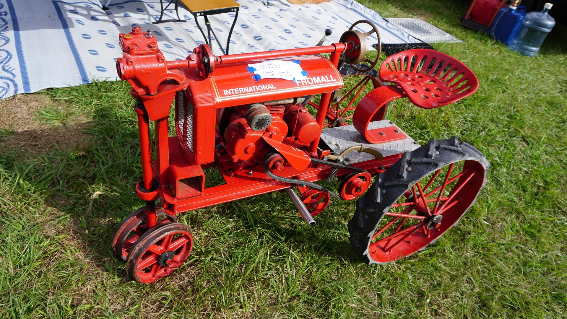 Not a Farmall, A FromAll - as in the parts to build this knee high tractor came from all over. The steering wheel is a fire extinguisher top