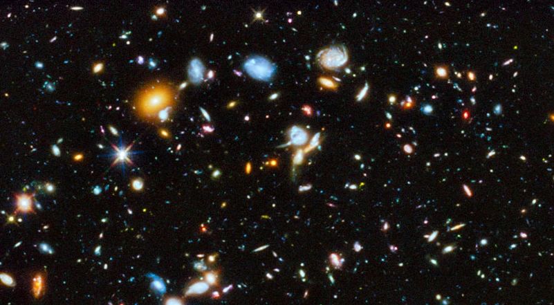 The Hubble Space Telescope has taken a long-exposure picture of space in the ultraviolet, revealing newly formed stars and galaxies (Image: NASA/ESA)