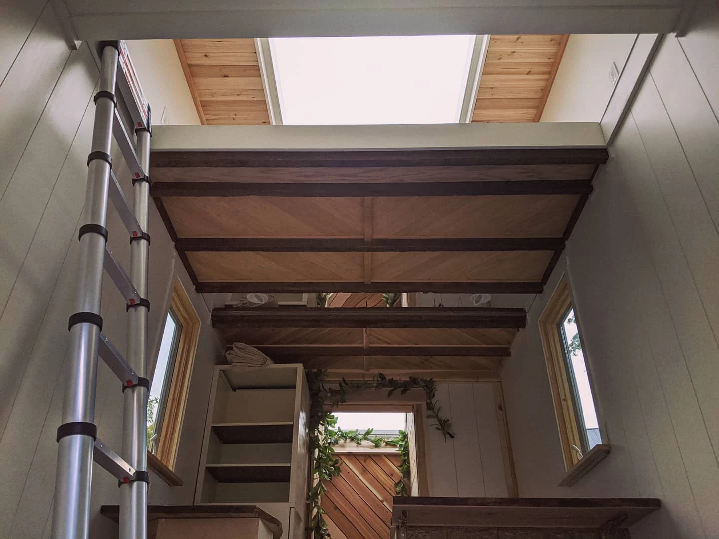 A series of ceiling mirrors have been positioned to trick the eye into making the compact interior space feel larger