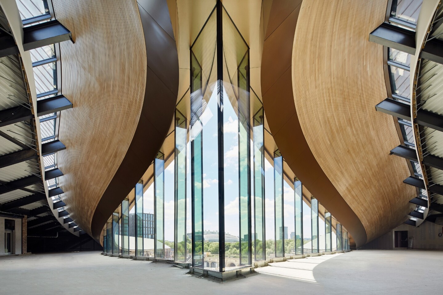 64 panels of full-height structural glass are arranged in a staggered, serrated pattern in Coal Drops Yard's uppermost floor