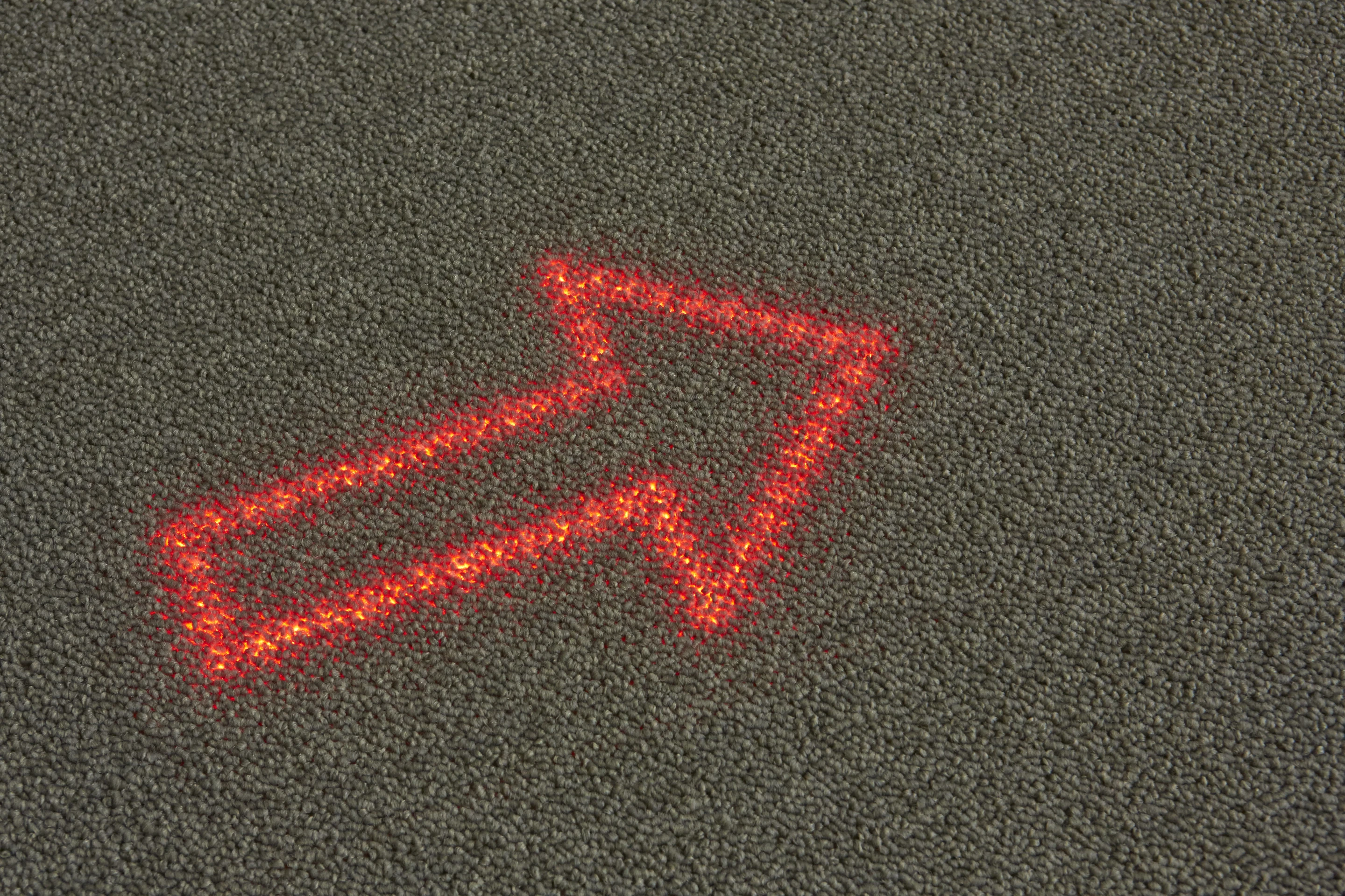 Philips and Desso have only mentioned that it will involve a layer of LEDs beneath a special light transmissive carpet, giving it the appearance of an ordinary carpet until it's lit