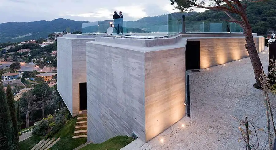 X House is built comfortably into the side of the hills in Cabrils, Spain