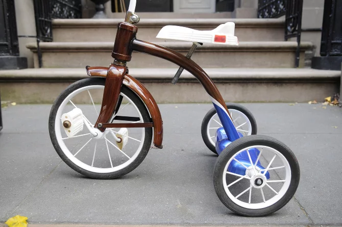 New Zealand's Rob Pollock hand-paints clients' bicycle (or tricycle) frames with a faux woodgrain finish