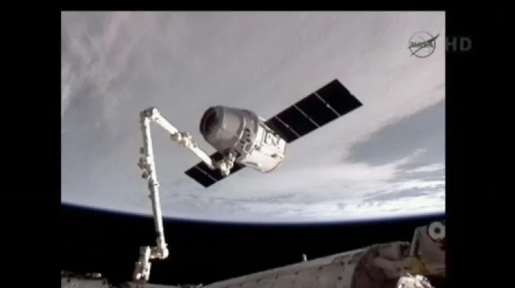 The Dragon spacecraft, held by the ISS manipulator arm (Image: NASA)