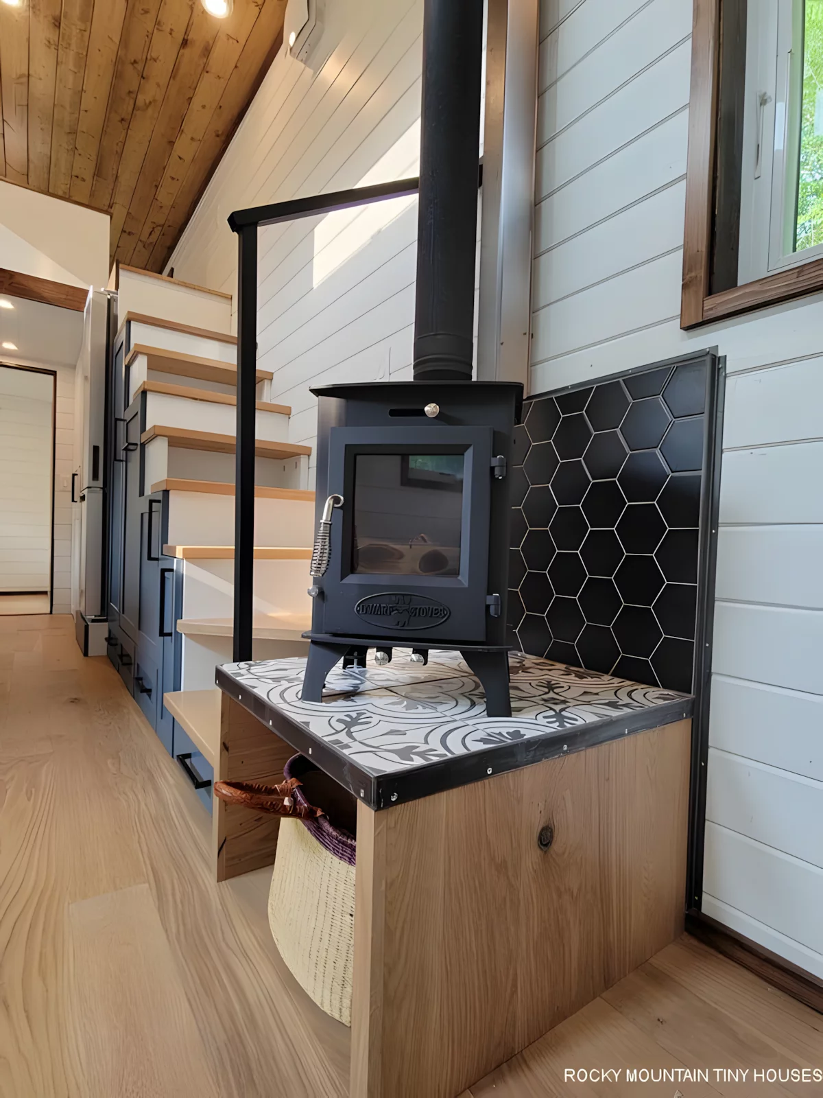 The Bandelier's living room is kept a comfortable temperature with an air-conditioning unit and a wood-burning stove