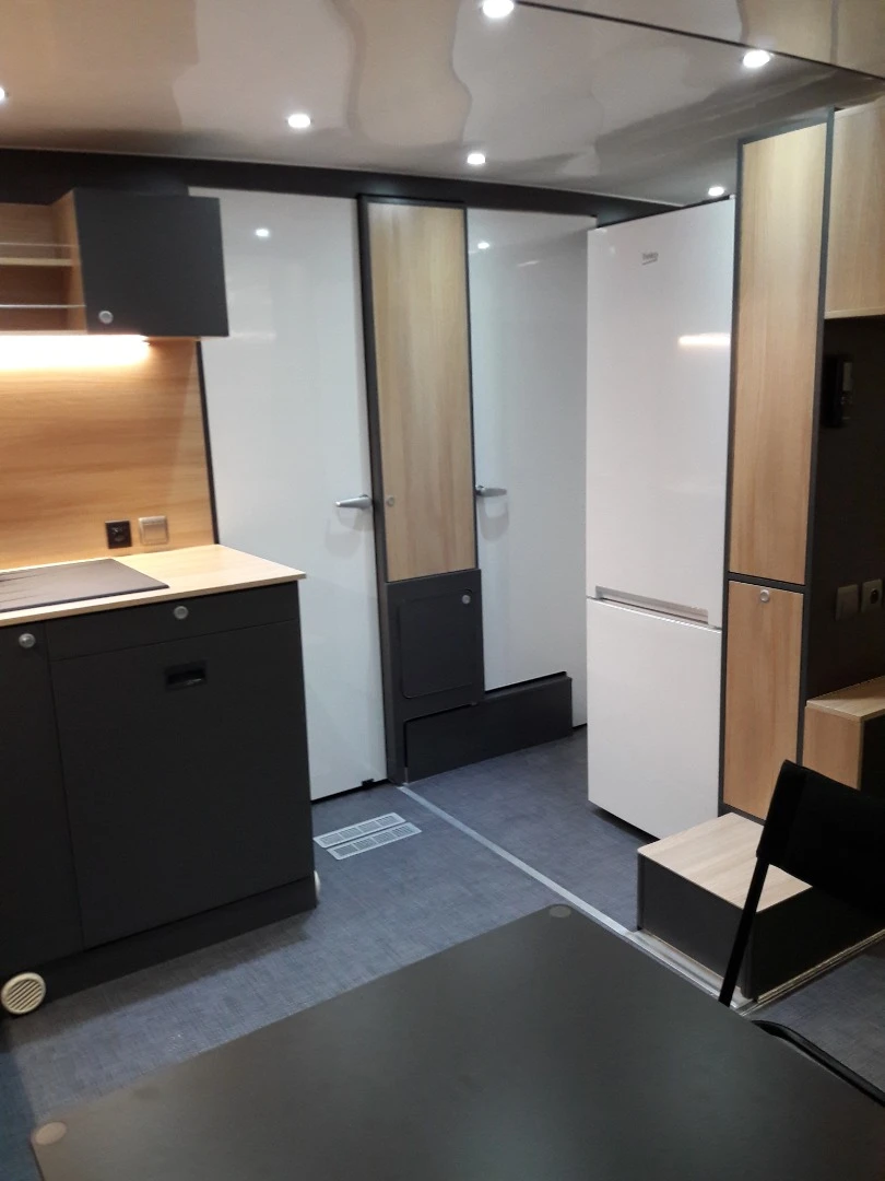 The bathroom is located across the hall from the kitchen