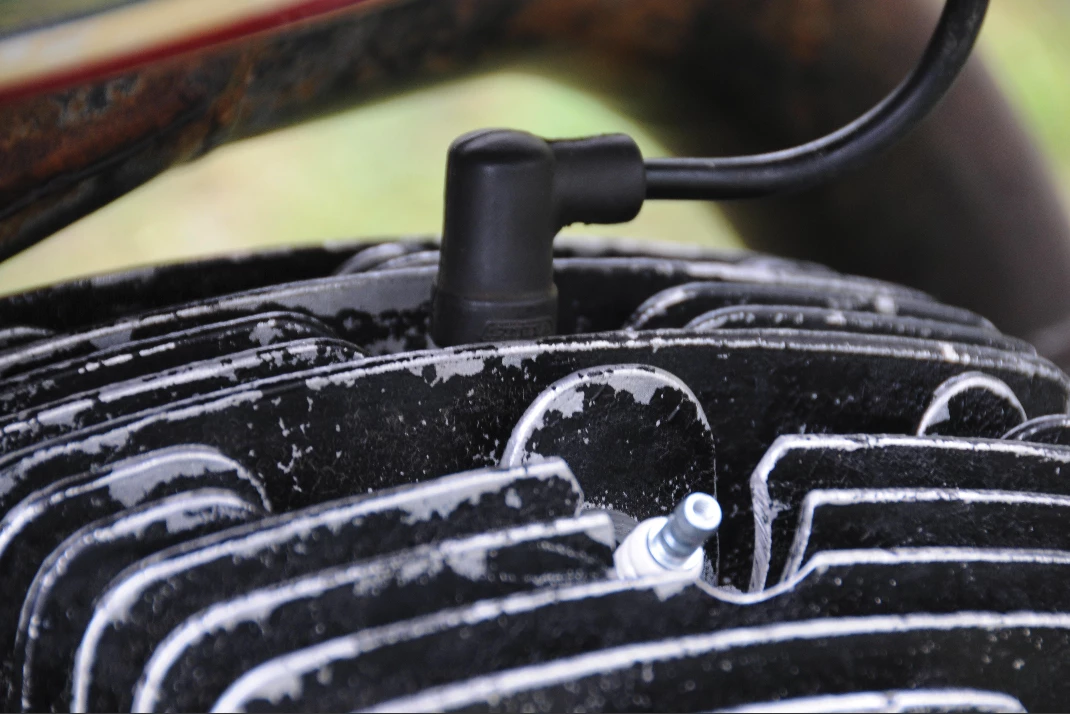 Quoting from McQueen Online: ... the 'On Any Sunday' motorcycle that he (McQueen) rode can be seen to have a compression release. The lever can be seen on the left side of the handle bars. The motorcycle cylinder head must be modified, professionally, with a second sparkplug hole to install this release (the Husqvarna factory never supplied this option), and (this) bike does have the modified cylinder head. Also, the exhaust pipe on the 'On Any Sunday' bike appears to have a modified tail pipe, and again, (this) bike has a modified tail pipe. Lastly, the bike was bought by Solar Productions on February 9, 1970 and the McQueen/Elsinore race featured in the film took place on March 7-8, 1970.