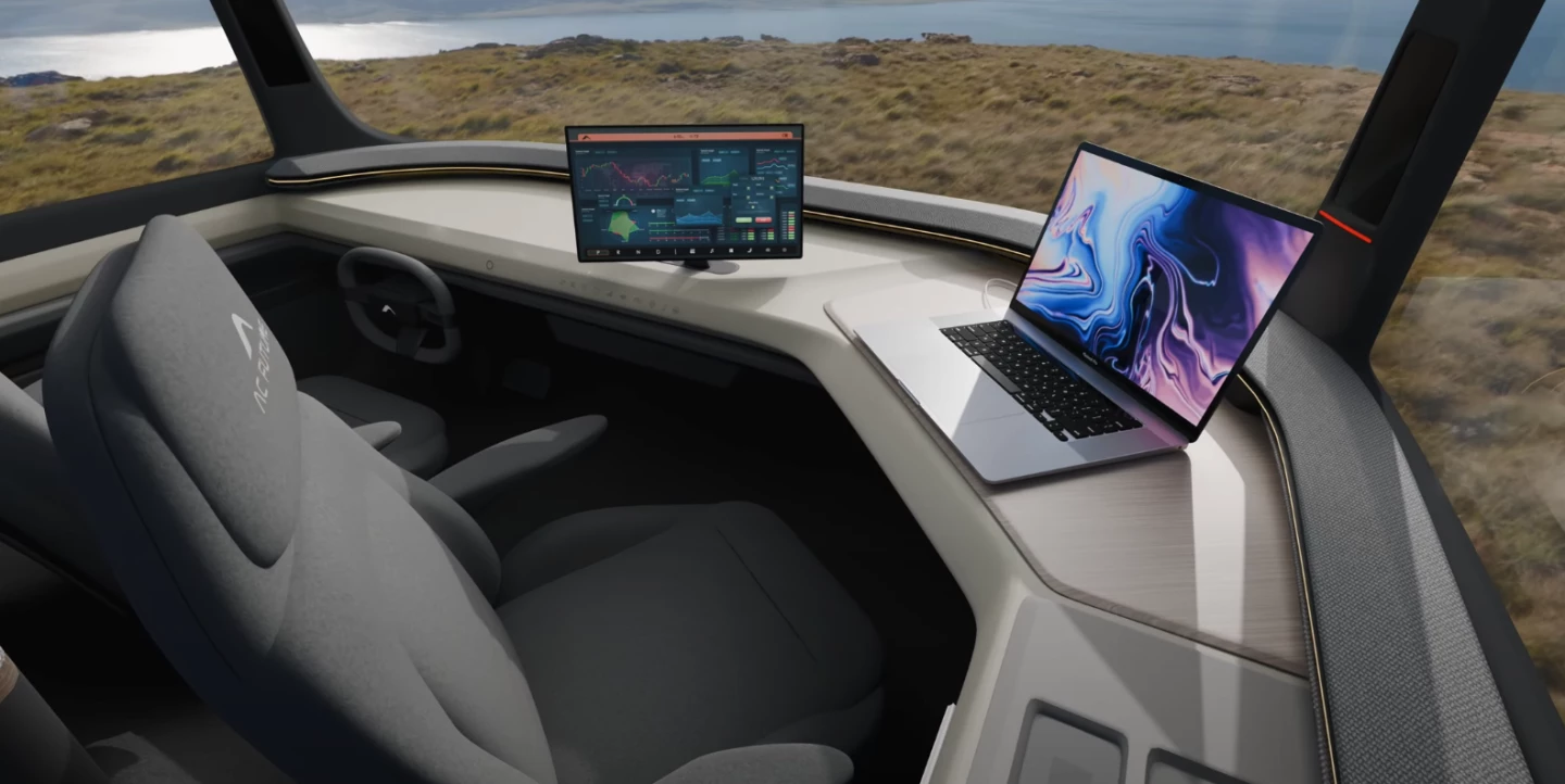 The AC Future eTH's low dashboard becomes a mobile workstation when parked, the steering wheel ducking down, and the infotainment display rotating