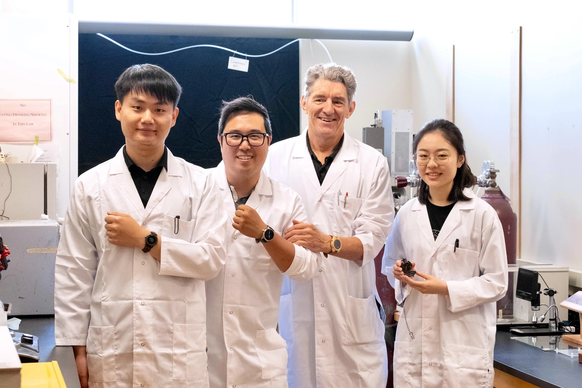 (From left) Team members Dengcheng Feng, Kenny Cheng, Prof. Philip Evans and Sara Xu with their Nxylon watches
