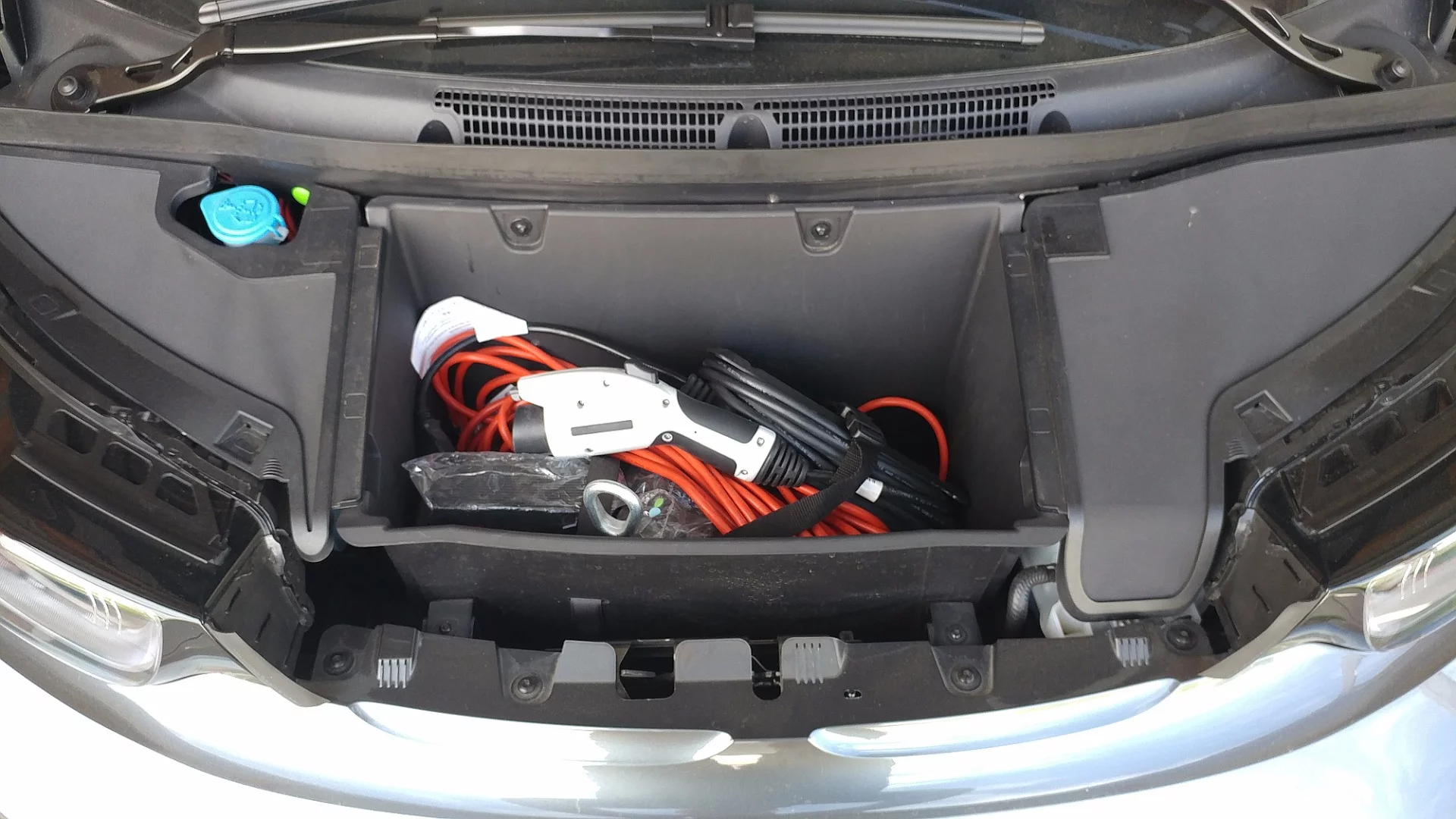 The small front storage compartment under the BMW i3's hood carries the charging equipment