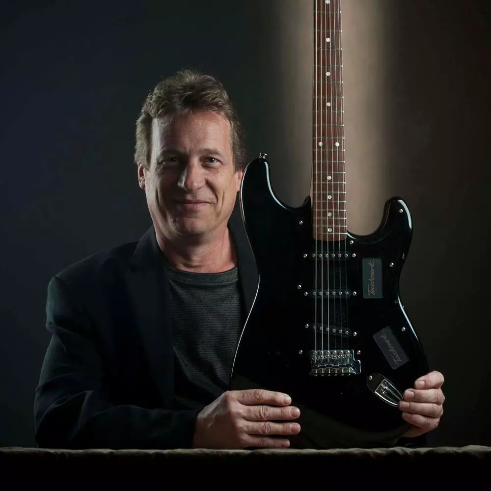 Los Angeles industrial designer and keen guitarist Mark Andersen with his Touchmark Guitar