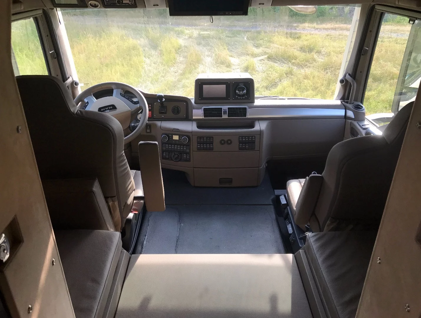Unicat has moved the handbrake from the space between the seats to the dashboard, freeing the center of the cab for a third seat, storage and/or easy access to the rear storage bench and cabin pass-through