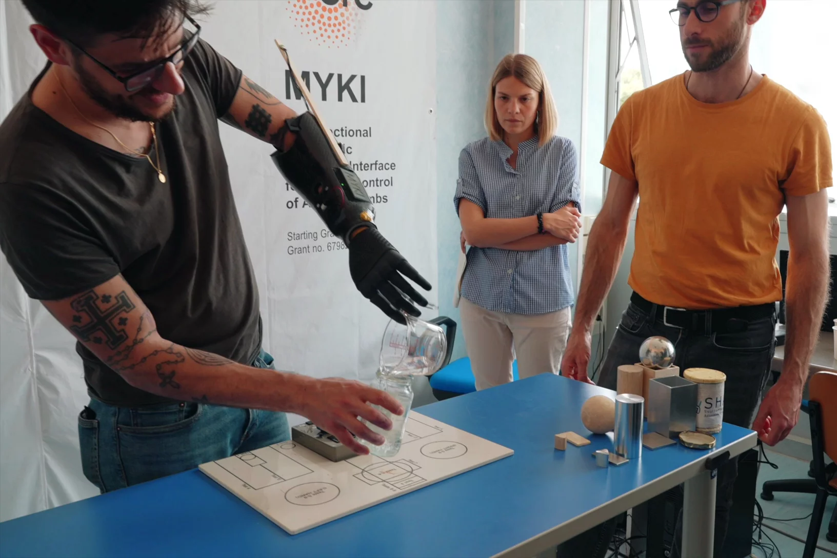 Daniel uses the hand to pour water from a cup