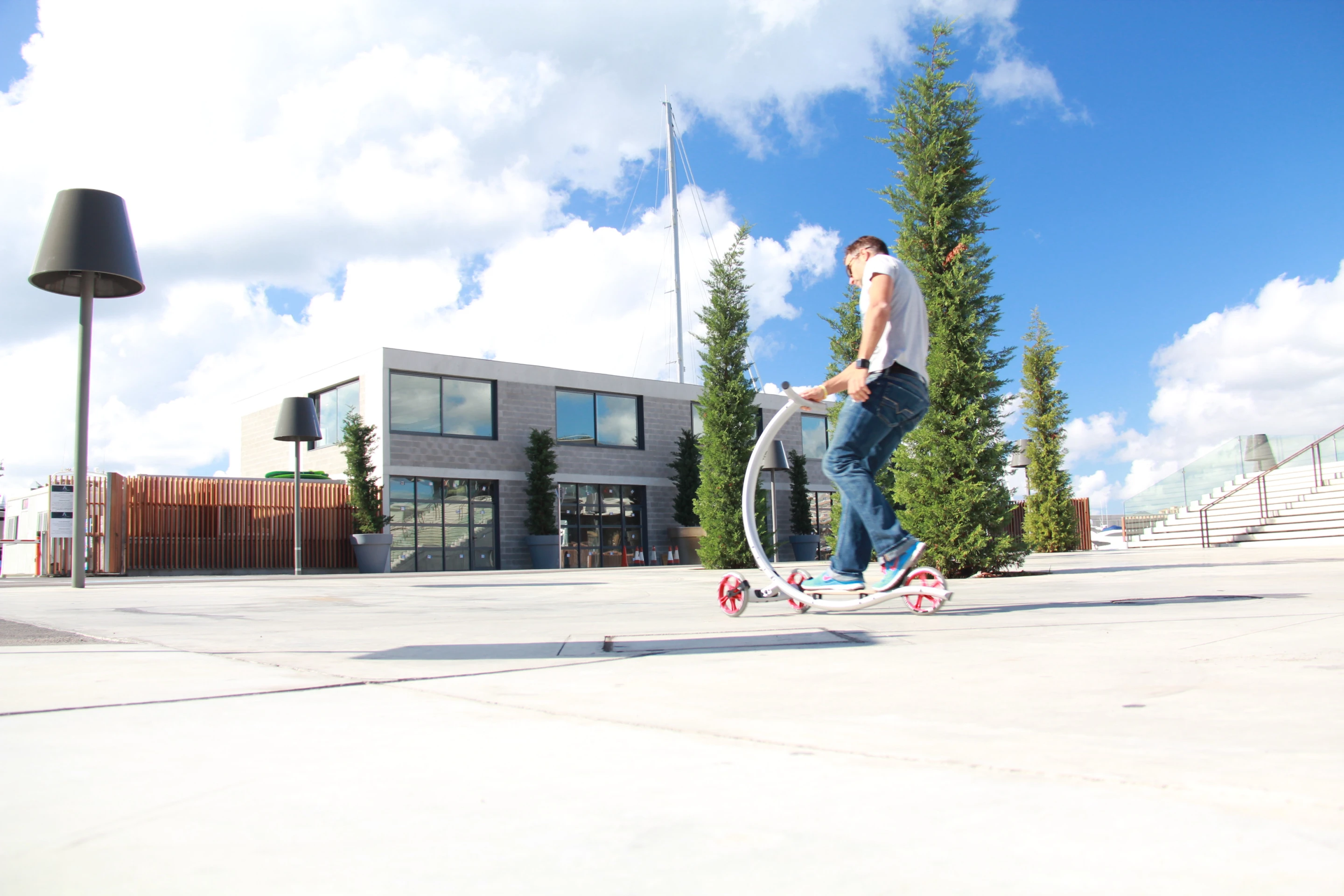 Three wheels and a two-piece, curved aluminum frame