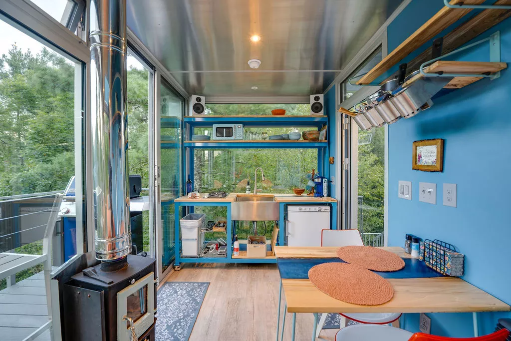 The River Forest Lookout has a small and simple kitchen area with a mini-fridge, microwave, sink, and a two-burner propane-powered stove