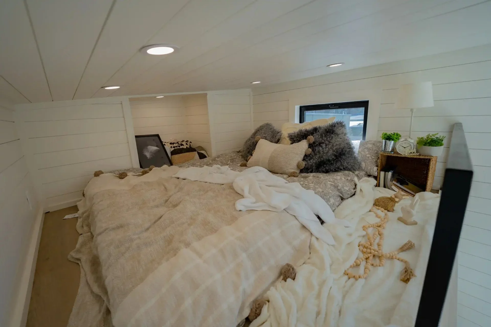 The Genesis' loft-style bedroom has a low ceiling and a double bed