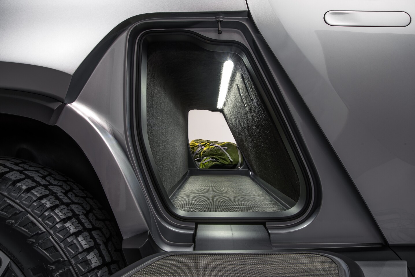 Rivian gives the R1T a storage tunnel that passes cleanly from one side to the other