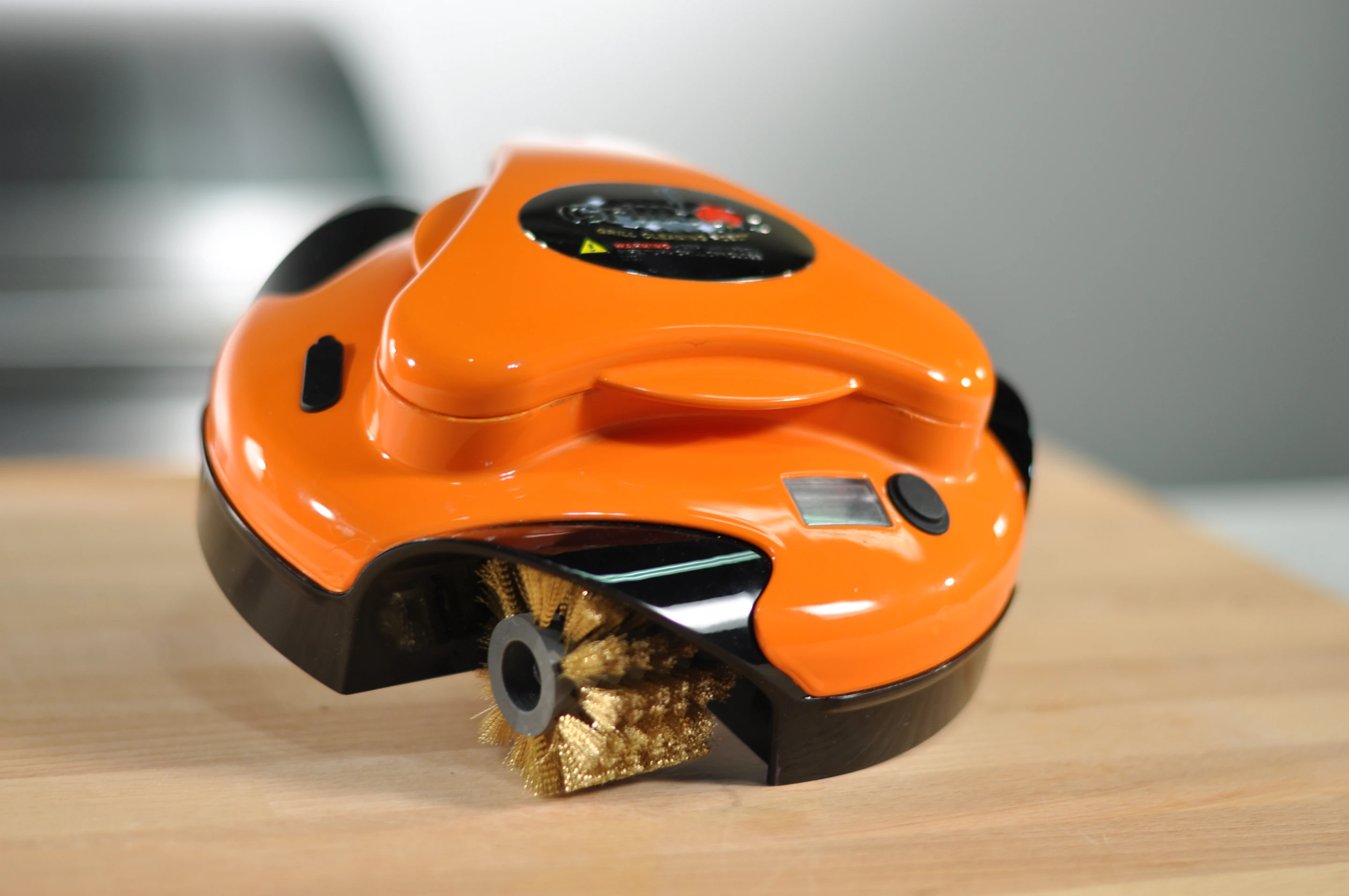 The Grillbot is a cute, single button operated bot that perches on your grill and lives to clean