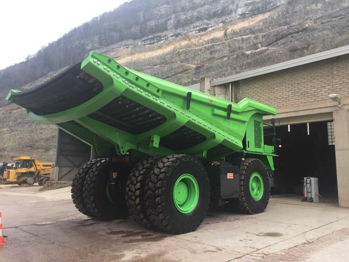 It drives up the hill empty, then rolls down with 60 tons of rock on board, regenerating almost all the power it uses on the way up