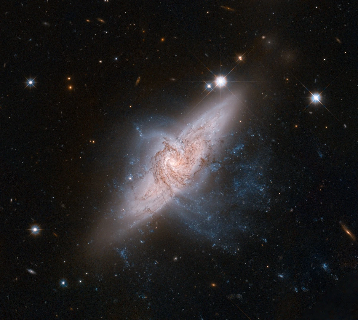 A pair of overlapping galaxies called NGC 3314. While the two galaxies look as if they are in the midst of a collision, this is in fact a trick of perspective: the two are in chance alignment from our vantage point