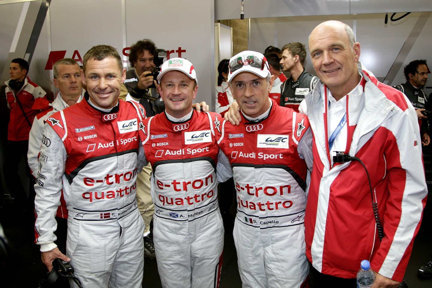 The pole-winning Audi e-tron quattro team of Tom Kristensen, Alan McNish and Dindo Capello alongside Audi's motorsport head Dr Wolfgang Ulrich.