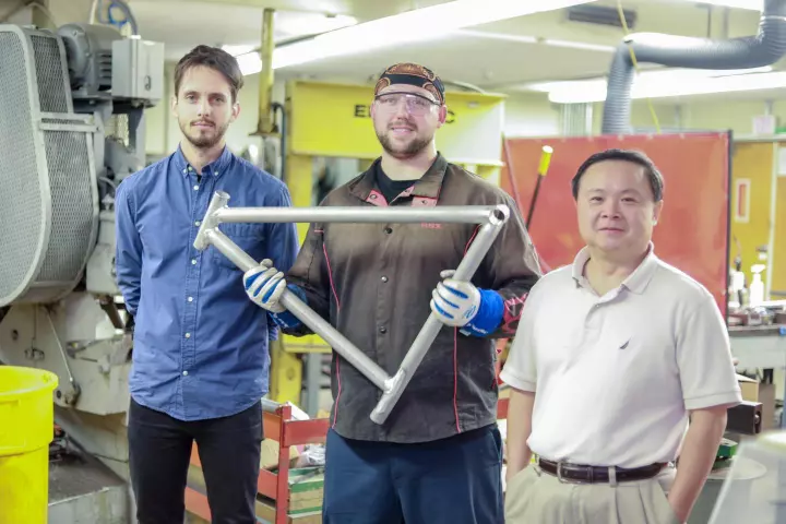 Grad student Maximilian Sokoluk (left), laboratory mechanician Travis Widick and Prof. Xiaochun Li, with a prototype welded AA7075 bicycle frame