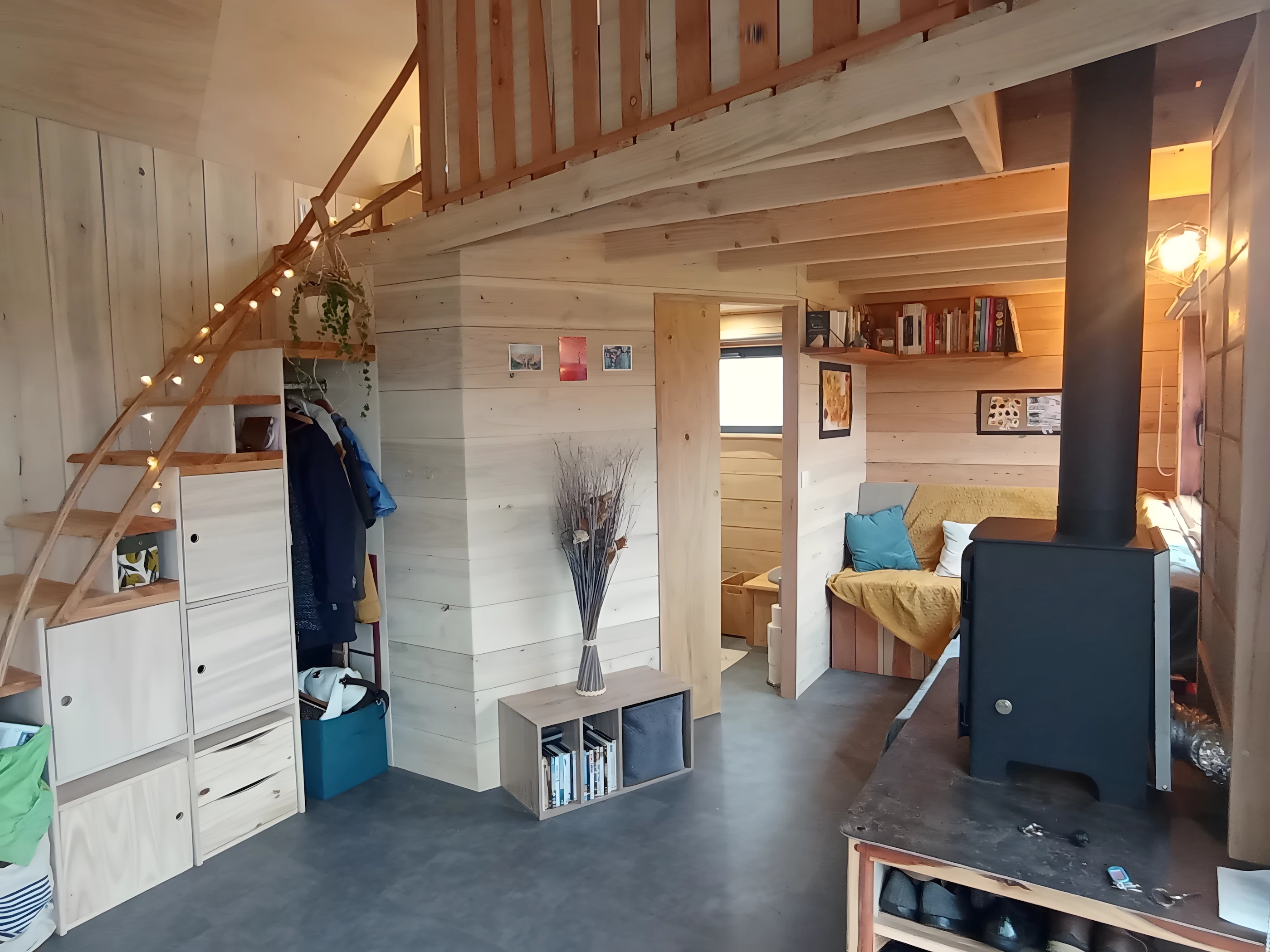 The Tiny XXL's living room looks quite snug and has a small wood-burning stove installed for warmth