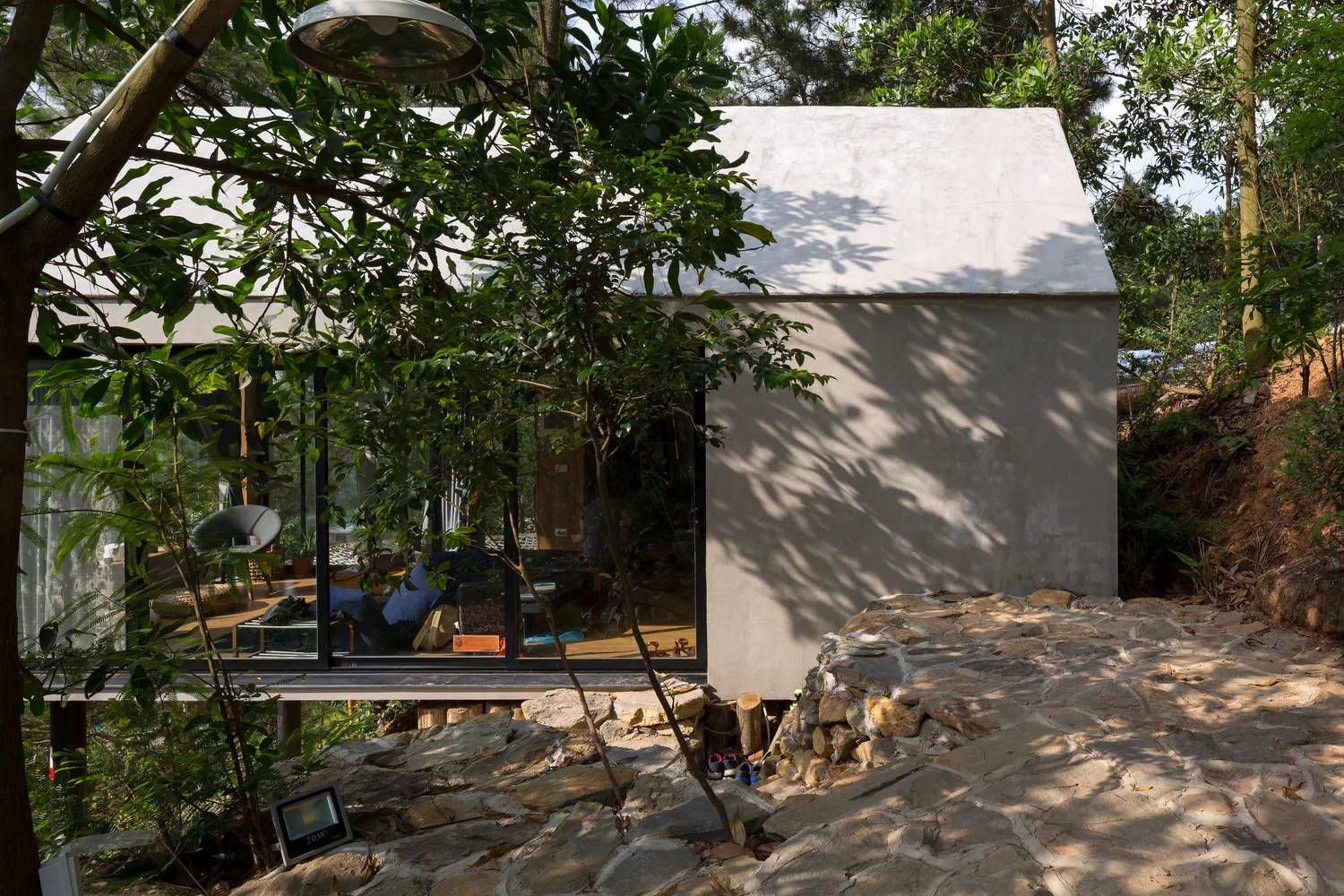 Side view of the tiny house from the lush landscape