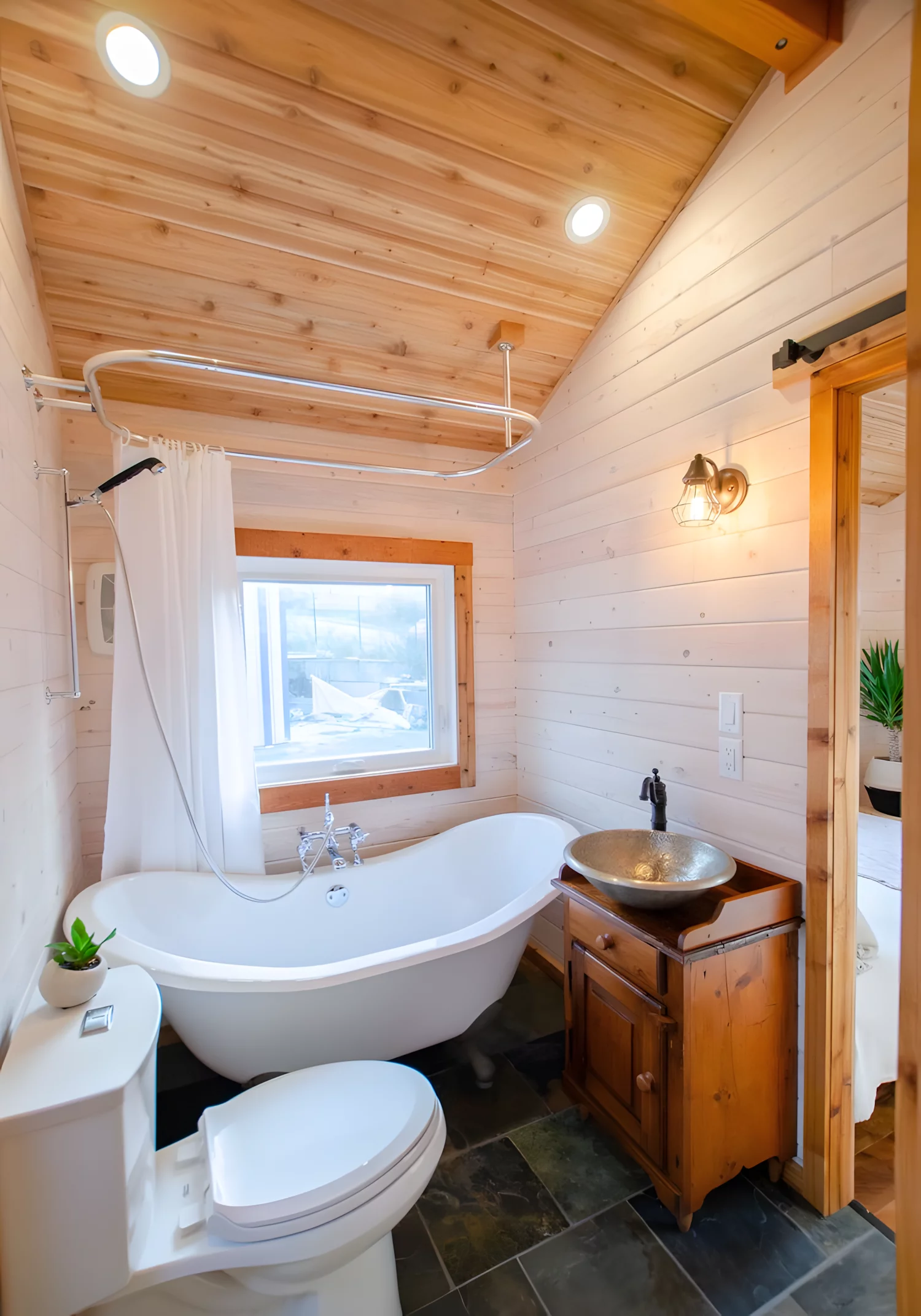 The Huckleberry's bathroom includes a bathtub/shower, which is a rare luxury in a tiny house