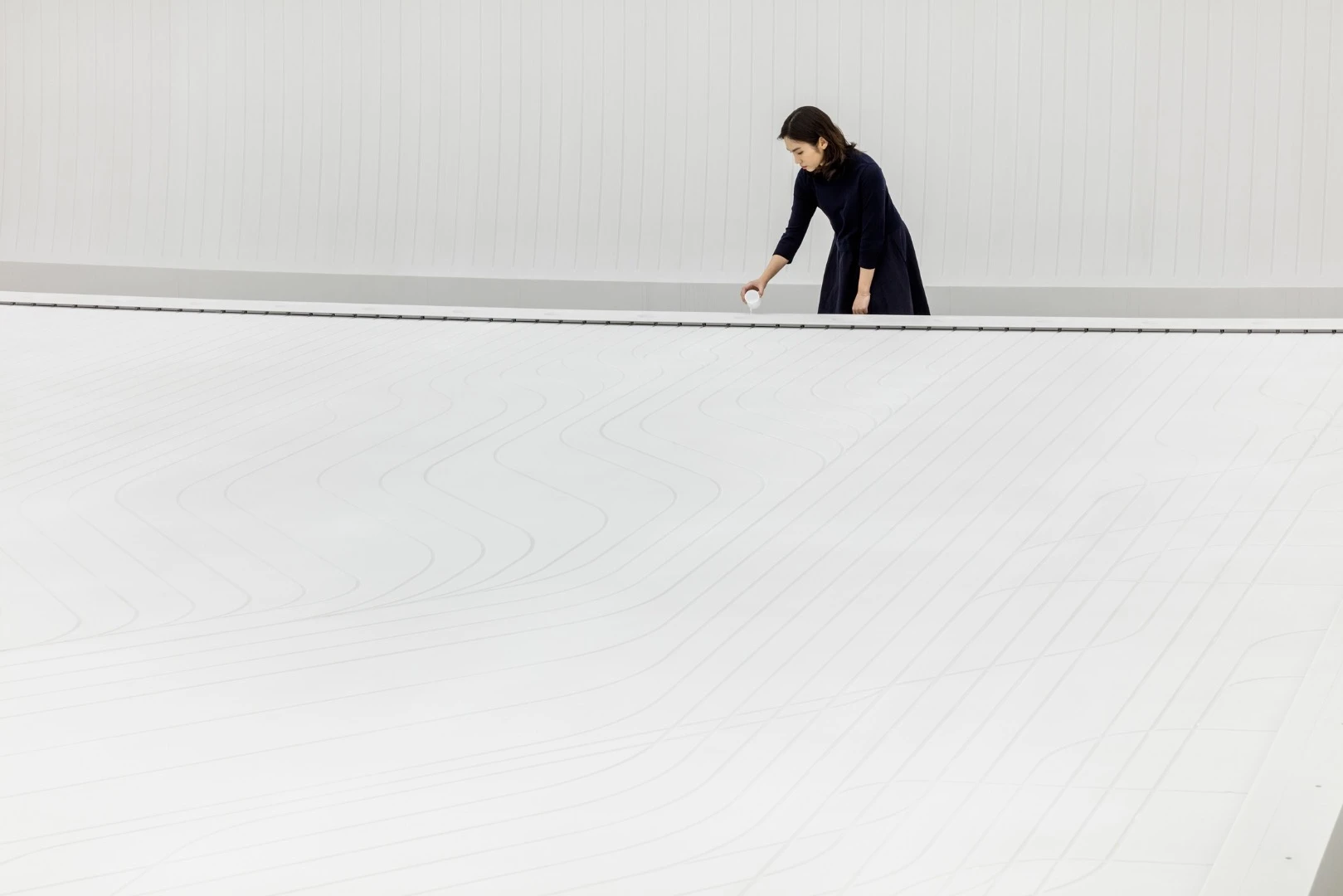 The water installation inside uses water droplets to create a visage resembling the sight of a giant city from space