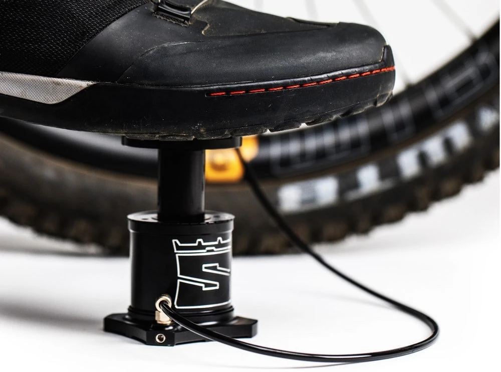 Small enough to be carried on the frame, the Stompump gets placed on the ground and attached to the tire's Presta or Schrader valve stem via an included hose, after which the rider … well, they stomp on it