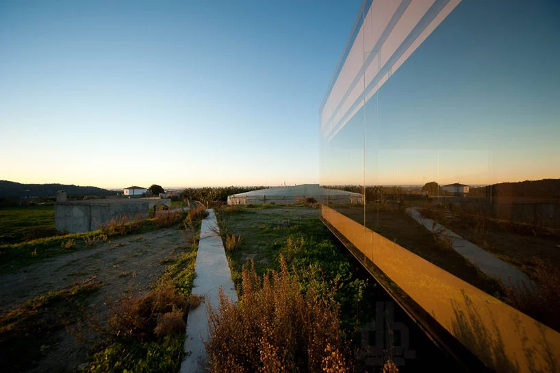 The main facade of the structure boasts impressive floor to ceiling glass panels, which reflect the surrounding landscape views