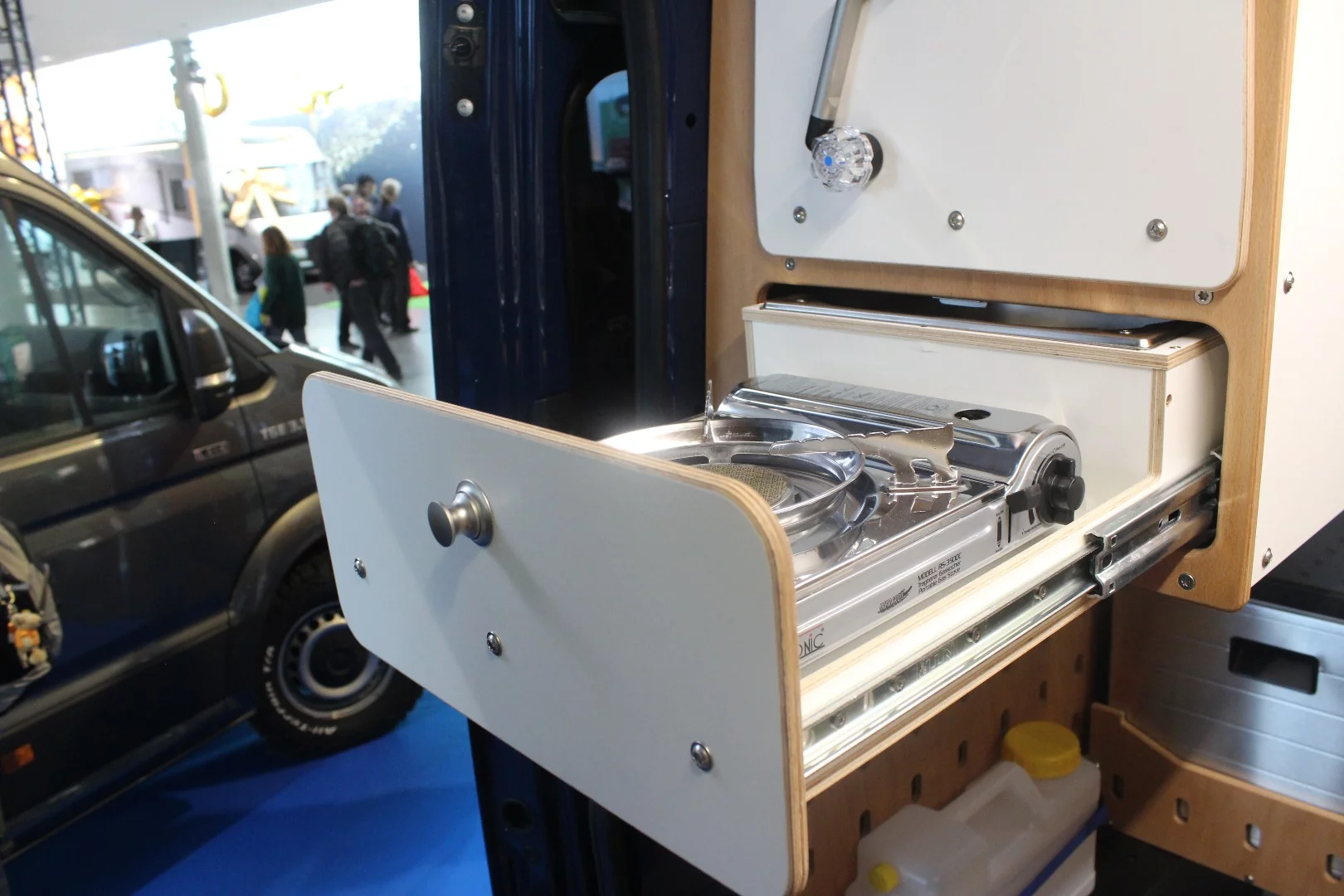 Below the sink drawer is a slide-out stove - you can remove the stove and place a wash basin here to work with the faucet