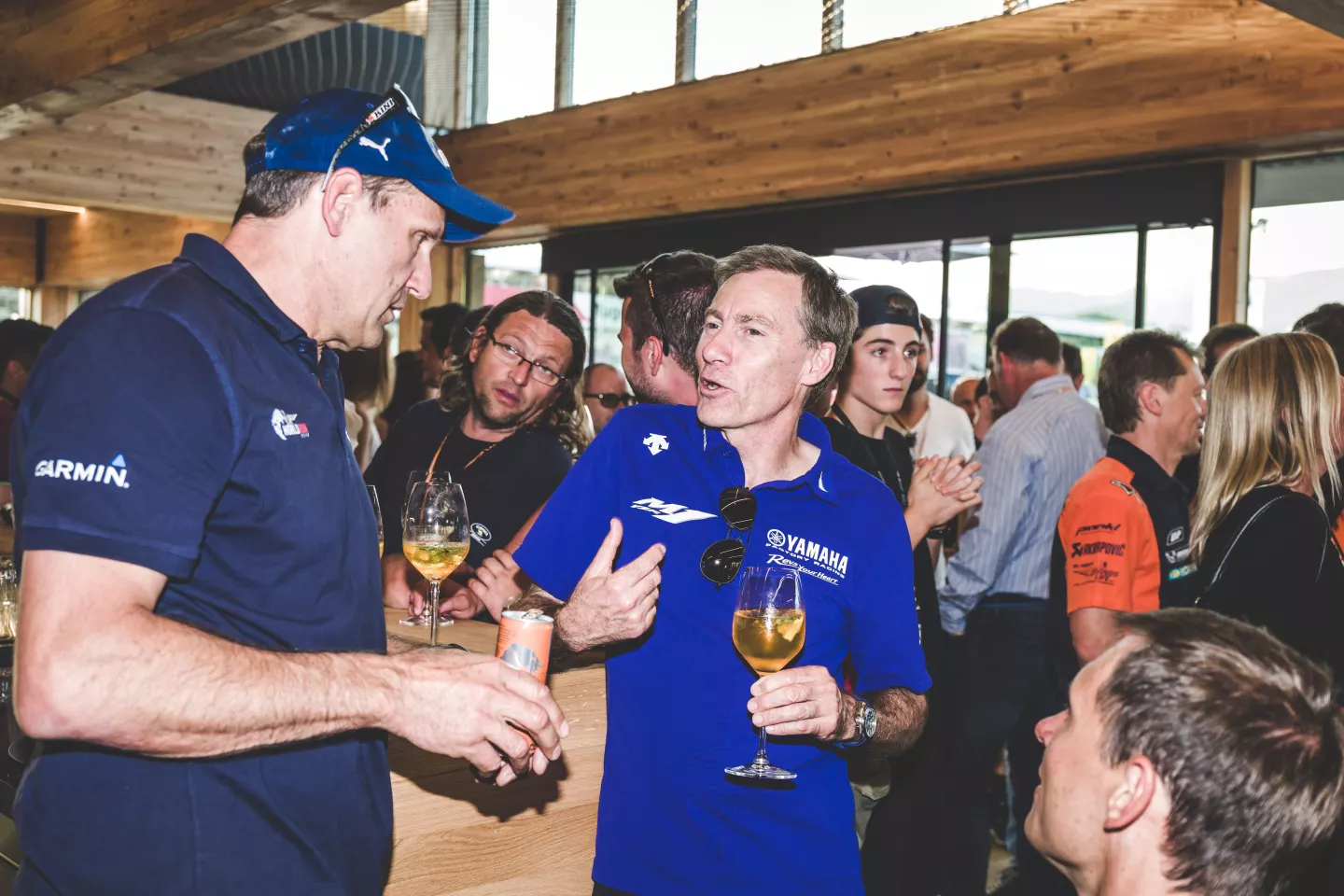Inside the Red Bull Energy Station is hallowed ground for race fans. That’s a conversation between KTM Sporting Director Heinz Kinigadner and Lin Jarvis, the Managing Director of Yamaha Motor Racing. Kinigadner won consecutive 250cc motocross world championships in 1984 and 1985 riding KTM, then directed the company’s rally development to global domination levels.