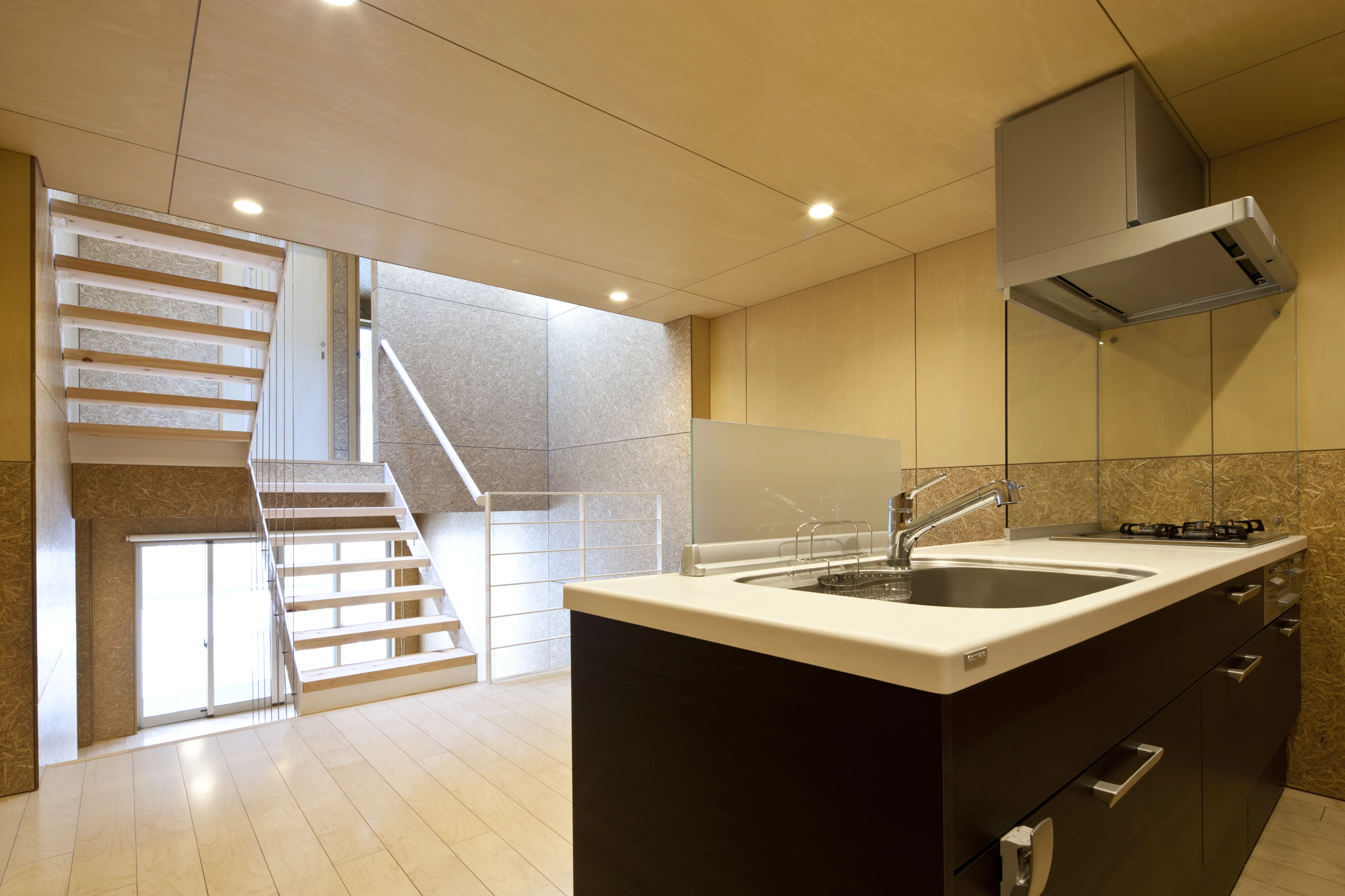 The modern, open-plan kitchen looks out onto the living room as light pours in through the slats in the steel outer shell (Photo: Stirling Elmendorf)