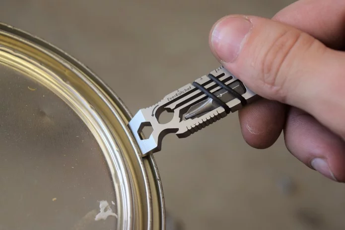 The EverRatchet multitool's scraper implement at work opening a tin of paint