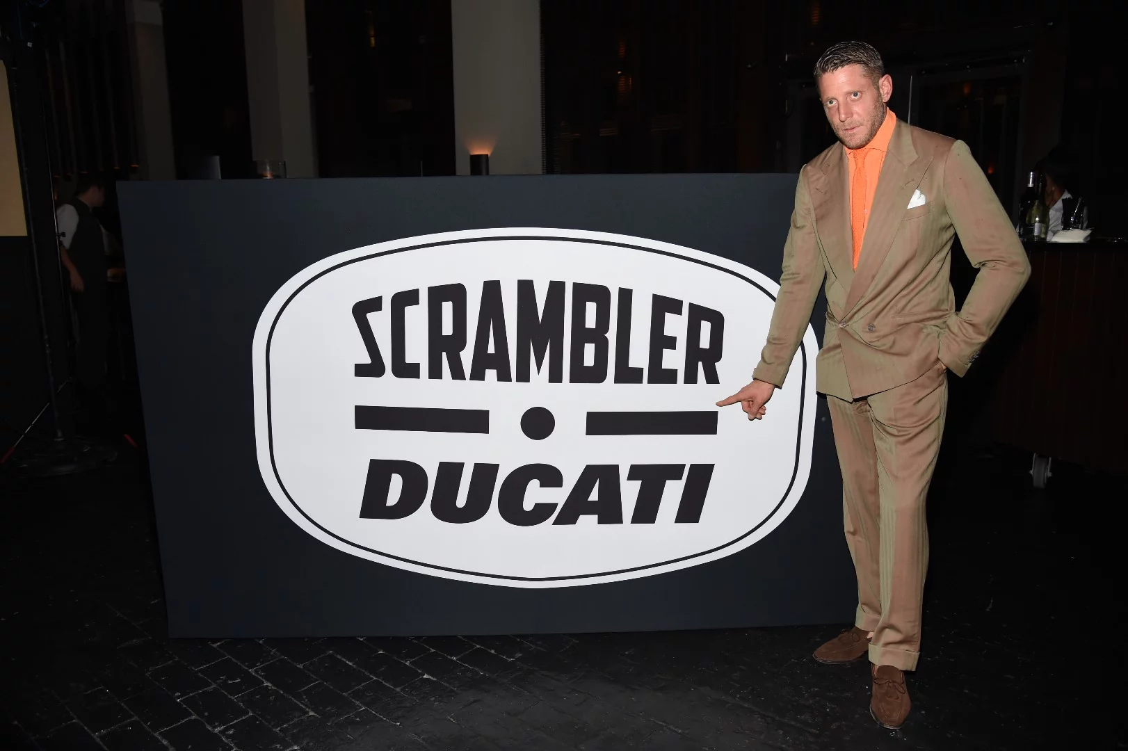 Lapo Elkann of Italia Independent standing next to the box containing the Ducati Scrambler prior to the reveal