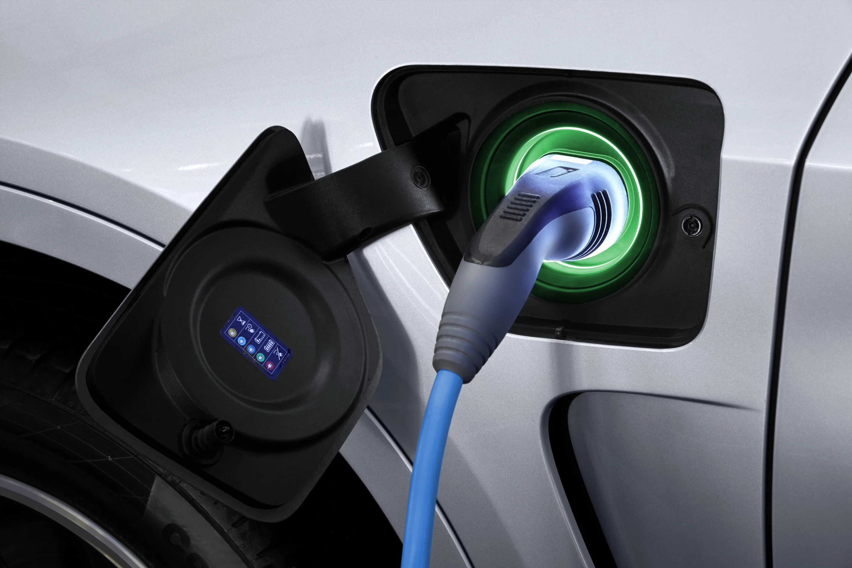 The plug-in charging port is located on the trailing edge of the left front fender