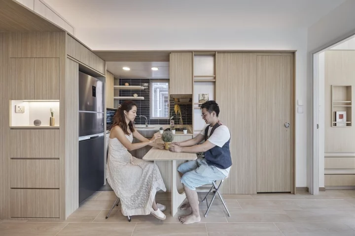 The tiny 367 sq ft (34 sqm) apartment features a U-shaped kitchen with adjoining bench seating