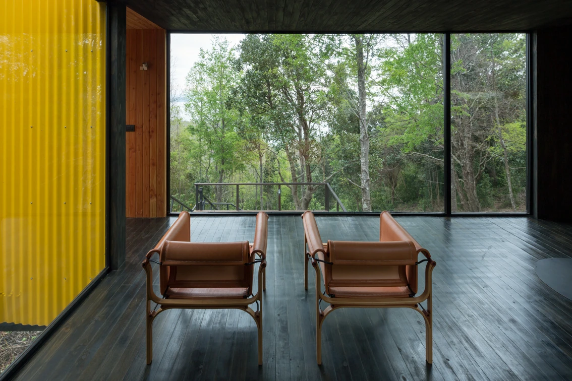 Large floor-to-ceiling glass windows fill the home with an abundance of natural light