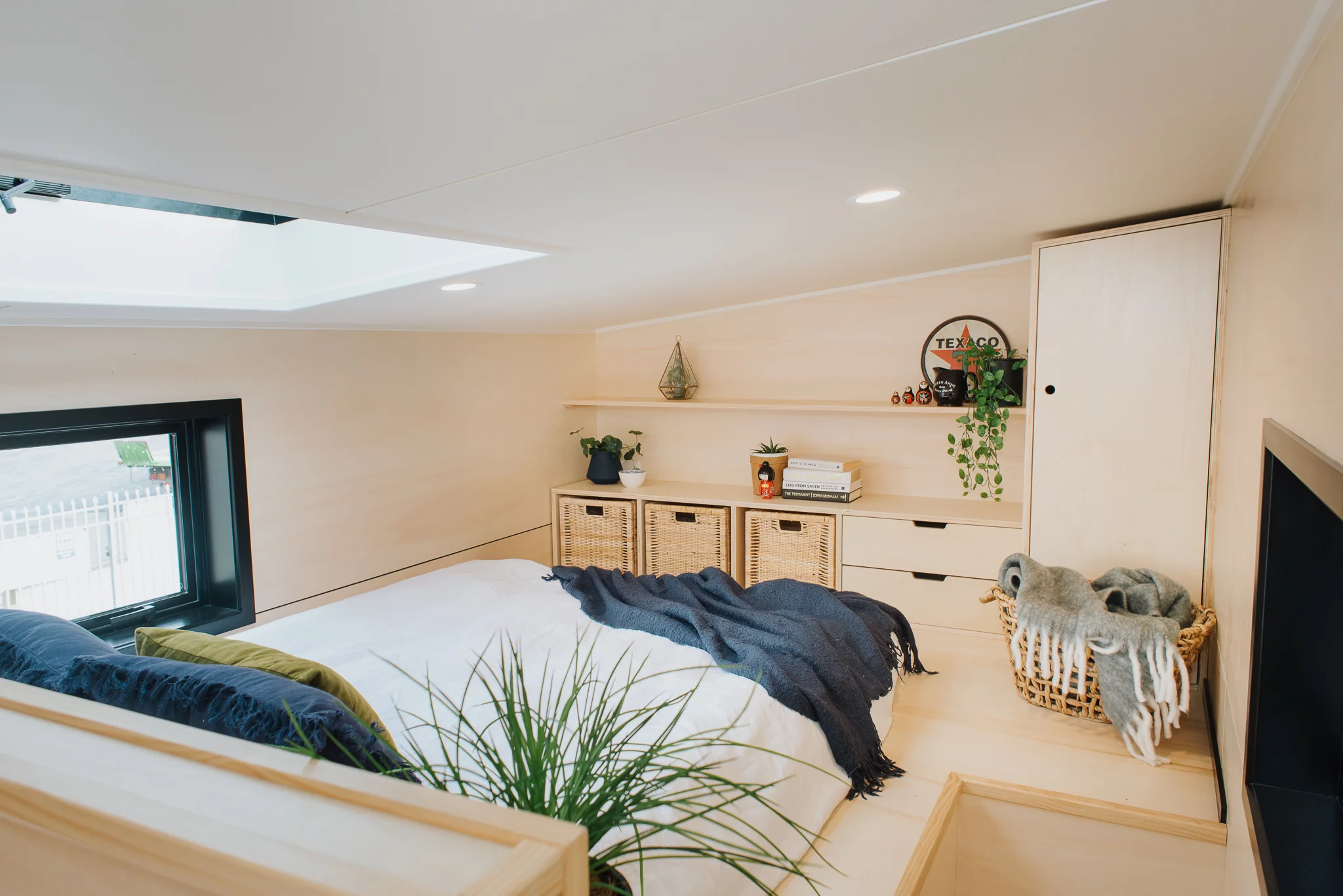 The Daisy Vera Tiny House's bedroom includes a double bed and some storage space