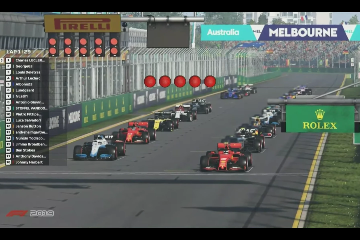 Virtually indistinguishable from the real deal on television, other than the names. That's Charles Leclerc's Ferrari on pole, George63 is George Russell in the Williams, Louis Delétraz is a Swiss Formula 2 driver, Arthur Leclerc is an ADAC F4 chamdriver, Charles' younger brother and a Ferrari Academy driver, Albono23 is Red Bull Racing's Alexander Albon, Lundgaard is Formula 2 driver Christian Lundgaard, NLatifi is Williams F1 driver Nicholas Latifi, Antonio Giovinazzi is an Alfa Romeo F1 driver and Stoffel Vandoorne is a Mercedes driver in Formula E. Other notables in the field are former world F1 champ Jenson Button, British cricketer Ben Stokes and former F1 star and commentator Johnny Herbert